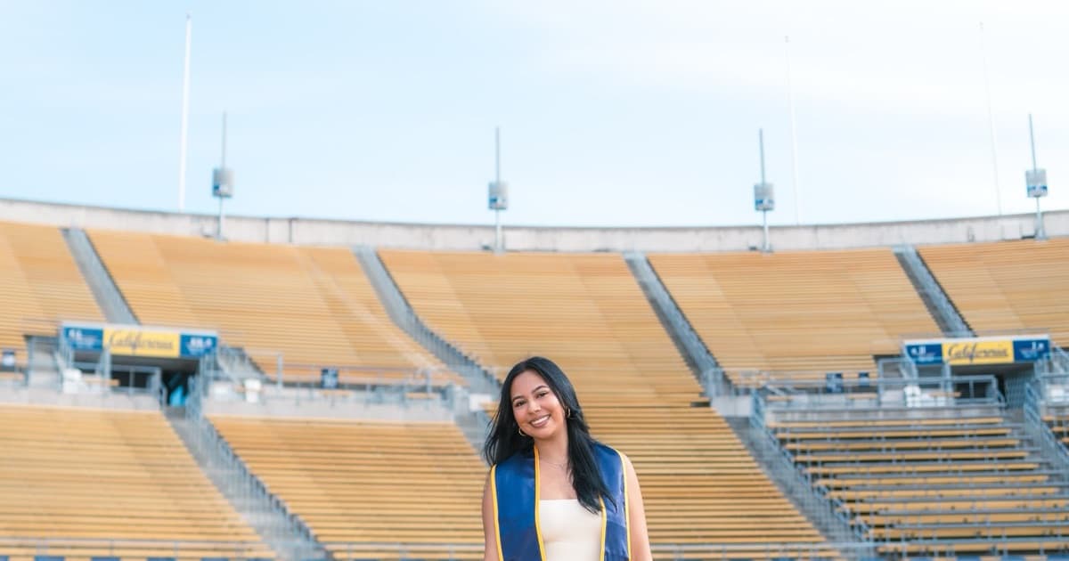 Graduate on the field at California Memorial Stadium.